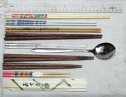 Various chopsticks, from top to bottom, with 12-inch (30.5 cm) ruler at top for scale: Taiwanese plastic chopsticksChinese porcelain chopsticksTibetan bamboo chopsticksVietnamese palmwood chopsticksKorean stainless steel flat chopsticksKorean matching spoon in a sujeoJapanese palmwood couple's set (two pairs)Japanese child's chopsticksDisposable chopsticks from Japan (in paper wrapper)