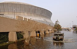 A United States National Guard humvee patrols Poydras Street outside of the Superdome.