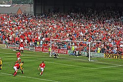 A penalty being scored by Ryan Valentine (red, no. 3).