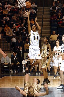 A player releases a short jump shot, while her defender is either knocked down, or trying to "take a charge".