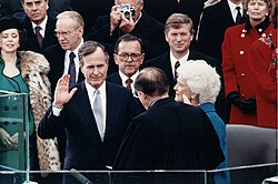 Bush takes the oath of office administered by Chief Justice William Rehnquist at the Capitol, January 20, 1989.