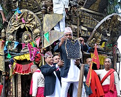 A Nepali man in Daura-Suruwal, coat and Dhaka topi, displays the bhoto during the Bhoto Jatra festival.