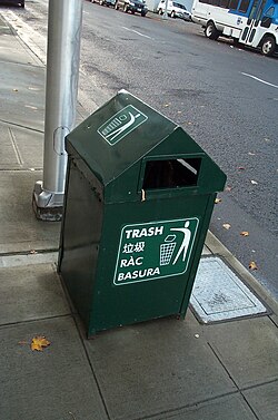 A trash can in Seattle labeled in four languages: English, Chinese, Vietnamese, Spanish.