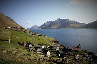 The village of Kunoy on Kunoy island, in the Faroe Islands. Kalsoy island is at right