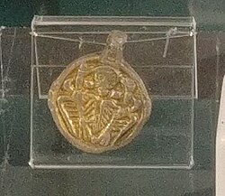 Pendant from Winteringham showing a man embracing two ravens