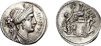 Denarius of Faustus Cornelius Sulla, 56 BC. It shows Diana on the obverse, while the reverse depicts Sulla being offered an olive branch by his ally Bocchus I. Jugurtha is shown captive on the right.[122]