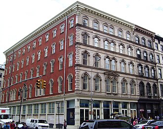 The Arnold Constable buildings at 307-311 Canal Street, with the red-brick Mercer Street facade. 309-311 (at the corner) is the original building, and 307 (center of block) was an addition.
