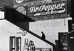 A black man goes into the "colored" entrance of a movie theater in Belzoni, Mississippi, 1939.[27]