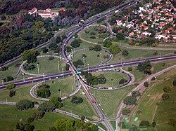 Cloverleaf interchange between the Ricchieri Freeway and the Ezeiza-Cañuelas Freeway, near Pistarini International Airport. The Barrio Uno subdivision is visible on the upper right-hand corner.
