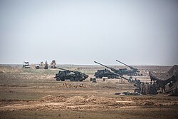 A joint Iraqi, French, and U.S. artillery battery in al-Qa'im, Iraq, 2 December 2018