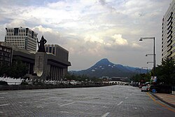 Sejong-daero in 2012, after the deduction from 16-lanes to 10-lanes of traffic, following the construction of Gwanghwamun Plaza with the statues of the Admiral Yi Sun-sin on the left
