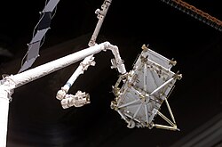 The Canadian-built Space Shuttle robotic arm (left), referred to as Canadarm, transferred the P5 truss segment over to the Canadian-built space station robotic arm, referred to as Canadarm2.[263]