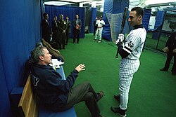 President George W. Bush taking advice before throwing the first pitch of World Series game 3, weeks after 9/11