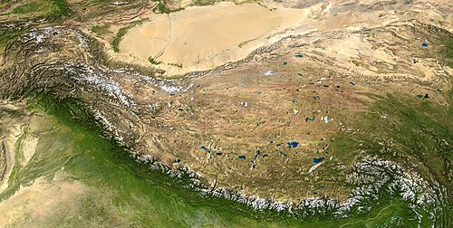 The Tibetan Plateau (center) is an example of a rain shadow. Rainfalls from the southern South Asian monsoon do not make it far past the Himalayas (seen by the snow line at the bottom), leading to an arid climate on the leeward (in this case, north) side of the mountain range and the desertification of the Tarim Basin (top).