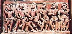 Draupadi with her five husbands – the Pandavas. The central figure is Yudhishthira; the two to his left are Bhima and Arjuna. Nakula and Sahadeva, the twins, are to his right. Their wife, at far right, is Draupadi. Deogarh, Dashavatara Hindu Temple.