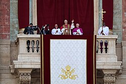 The newly elected Pope Leo XIV waving from the central loggia of St. Peter's Basilica in his first public appearance after the 2025 papal conclave