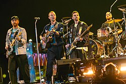 Coldplay, the most commercially successful post-Britpop band, on stage in 2024.[78] Their first three albums – Parachutes (2000), A Rush of Blood to the Head (2002) and X&Y (2005) – are among the best-selling albums in UK chart history.[79]