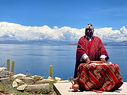A Yatiri, a traditional Aymara medical practitioner and community healer performing a ritual near Lake Titicaca in Bolivia
