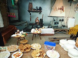 An old country house and traditional cuisine with Haliva (Хьэлжъо, Helɀwa) and Mataz (Мэтазэ, Metaze), two of the prominent traditional Adyghe snacks.
