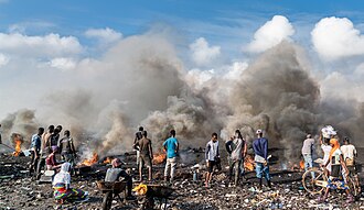 E-waste processing in Agbogbloshie, Ghana. Improper disposal of manufactured goods and industrial wastes, often means that communities in the global south have to process goods. Especially without proper protections, heavy metals and other contaminates can seep into the soil, and create water pollution and air pollution.