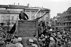 Lenin speaking to a crowd in Moscow's Sverdlov Square with Leon Trotsky and Lev Kamenev beside him, May 1920