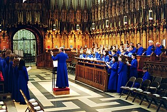 Evensong rehearsal by Blue Coat CE School Choir, Coventry, in the quire of York Minster, showing carved choirstalls