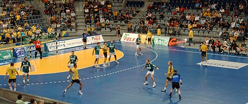 The referees (blue shirts) keep both teams between them.