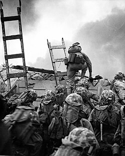 American Marines climbing a sea wall in Incheon during a decisive moment in the timeline of the Korean War