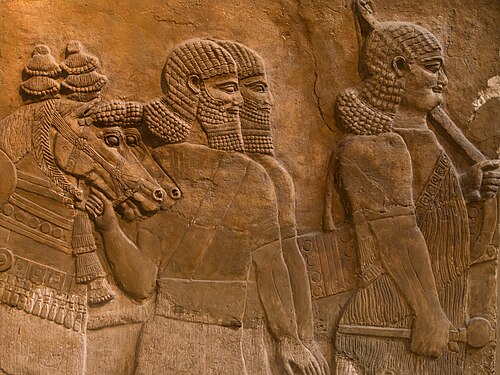 A neo-Assyrian relief of Assyrians in a procession