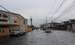 A normal city street in Puerto Rico that is completely flooded in a few feet of water.