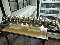 A 1.3 GHz 9-cell superconducting radio frequency cavity made from niobium is on display at Fermilab