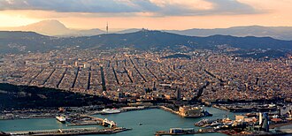 Aerial view of the centre and the Eixample, with the Serra de Collserola at the background
