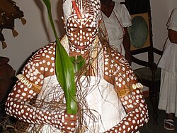 An initiation conducted in Bahia in 2008; the white clothes and white spots are worn at this ceremony[277]