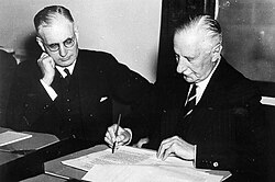 Governor General of Australia The Lord Gowrie (right) signing the declaration of war against Japan with Prime Minister John Curtin (left) looking on. (8 December 1941)