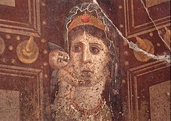 Fresco painting of Cleopatra depicted as the goddess Venus Genetrix wearing a diadem, holding a cupid and standing in the center of an open temple doorway