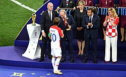 Luka Modrić accepting the Golden Ball award from Vladimir Putin