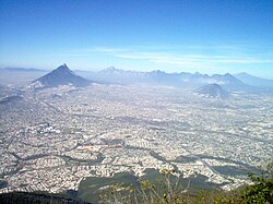 Monterrey seen from a Cerro de la Silla antenna. The mountain to the left in the background is Cerro de las Mitras; that on the right is Cerro del Topo Chico.