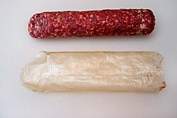 A salami and the collagen casing (below) it came in