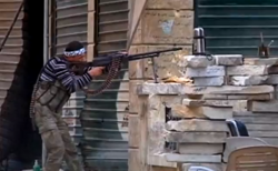 An FSA fighter engaged in a firefight in Aleppo