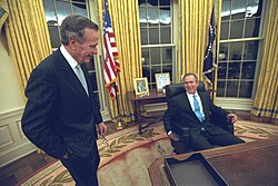 H. W. Bush (left) and his son George W. Bush in the Oval Office, January 2001