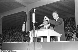 Billy Graham, a prominent evangelical revivalist, preaching in Duisburg, Germany, in 1954