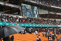 A jumbotron shows Zuma entering Mandela's memorial on 10 December 2013.