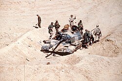 French and American soldiers inspecting an Iraqi Type 69 tank destroyed by the French Division Daguet during Operation Desert Storm