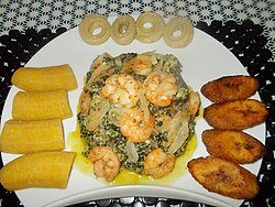Plantains and "Bobolo" (made from cassava) served with Ndolè (meat and shrimp)