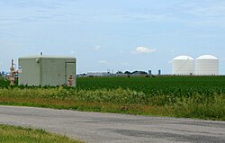 Peoples Gas Manlove Field natural gas storage area in Newcomb Township, Champaign County, Illinois. In the foreground (left) is one of the numerous wells for the underground storage area, with an LNG plant, and above-ground storage tanks are in the background (right).