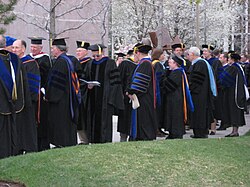 American academic doctors gather before the commencement exercises at Brigham Young University (April 2008). The American code for academic dress identifies academic doctors with three bands of velvet on the sleeve of the doctoral gown.