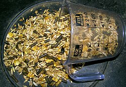 A commercially prepared grain mix for horses, with crimped maize, oats, and barley mixed with molasses and pelleted supplement