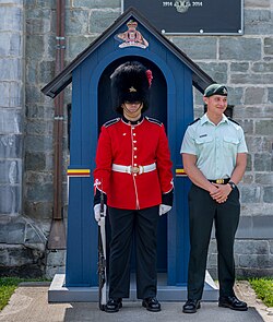 A Royal 22nd Regiment soldier in No. 1B ceremonial full dress alongside another in No. 3B service dress, 2018