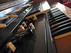 A close-up of the Hammond L-100 organ, with the drawbars in the foreground