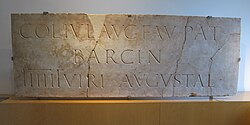 A marble plaque in the Museu d'Història de la Ciutat de Barcelona, dated from around 110–130 AD and dedicated to the Roman colony of Barcino